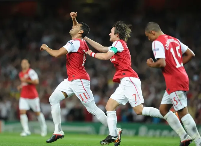 Framed Print : Arsenal Celebrate: Rosicky and Santos Score in Champions League Win over Olympiacos (2011-12)