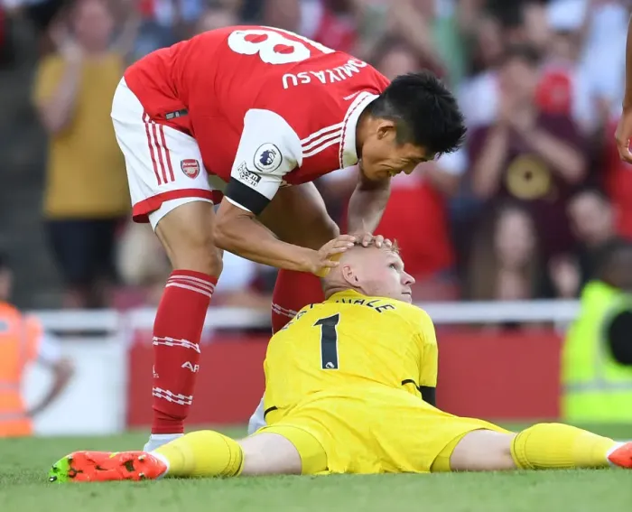 Framed Print : Arsenal Celebrate: Tomiyasu and Ramsdale Embrace Post-Goal at Emirates Stadium
