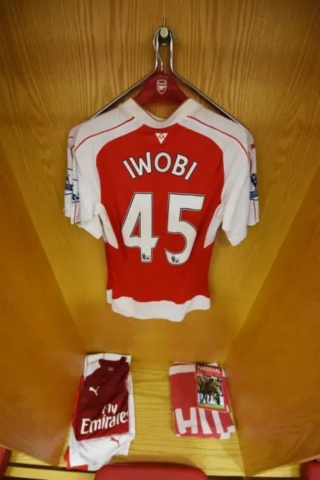 Framed Print : Arsenal Changing Room: A Pre-Match Glance at Alex Iwobi's Jersey (Arsenal vs. Watford, 2015-16)