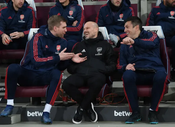 Framed Print : Arsenal Coaches Ljungberg, Mertesacker, and Bibbo Share a Lighthearted Moment on the Sidelines during Arsenal's Match against West Ham Framed Print : Arsenal Coaches Ljungberg, Mertesacker, and Bibbo Share a Lighthearted Moment on the Sidelines during Arsenal's Match against West Ham