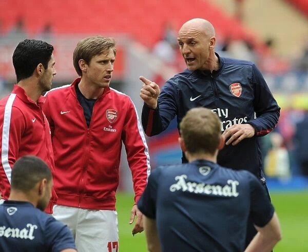 Arsenal Coaches Steve Bould, Nacho Monreal, and Mikel Arteta Discussing Strategy Before FA Cup Semi-Final vs Wigan Athletic