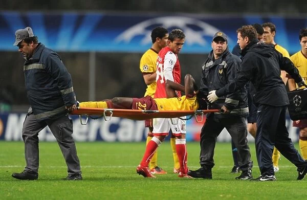 Arsenal defender Emmanuel Eboue is carried off after an injury to his ankle