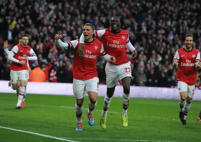 Framed Print : Arsenal Double Strike: Podolski and Sanogo Celebrate Goals Against Liverpool in FA Cup
