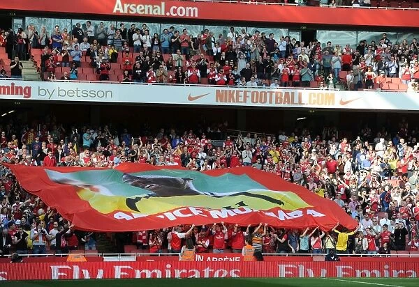 Arsenal fans with a banner to support former player Fabrice Muamba who collapsed whilst playing for Bolton. Arsenal 3: 0 Aston Villa. Barclays Premier League. Emirates Stadium, 24  /  3  /  12. Credit : Arsenal Football Club  / 