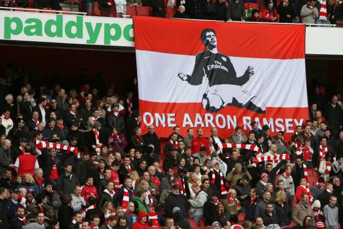 Framed Print : Arsenal fans have a banner supporting Aaron Ramsey who broke his leg in the previous match Framed Print : Arsenal fans have a banner supporting Aaron Ramsey who broke his leg in the previous match