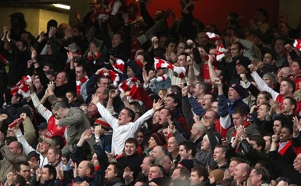 The Arsenal fans celebrate Emmanuel Adebayors 1st goal