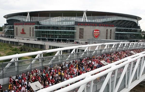 Arsenal fans cross the North Bridge after leaving the stadium
