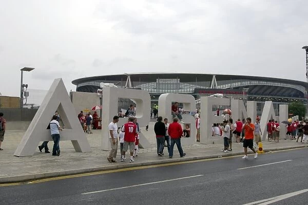 Arsenal fans gather outside the Emirates Stadium on thegiant letters near the south bridge