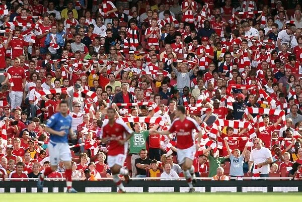 Arsenal fans hold up their scarves