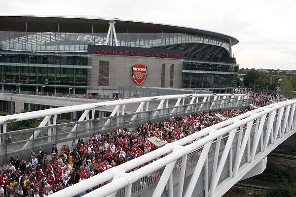 Arsenal fans leave the stadium crossing the North Bridge