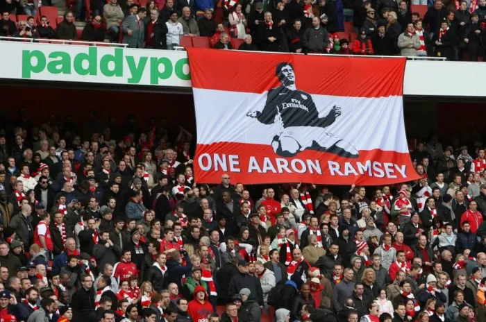 Framed Print : Arsenal Fans Rally Behind Injured Aaron Ramsey: Uniting in Support After His Broken Leg Against Burnley Framed Print : Arsenal Fans Rally Behind Injured Aaron Ramsey: Uniting in Support After His Broken Leg Against Burnley
