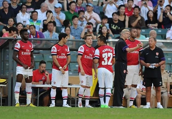 Arsenal FC: Arsene Wenger and Squad at Pre-Season Training in Hong Kong (2012) - Alex Song, Mikel Arteta, Thomas Eisfeld, Nico Yennaris, and Kyle Bartley
