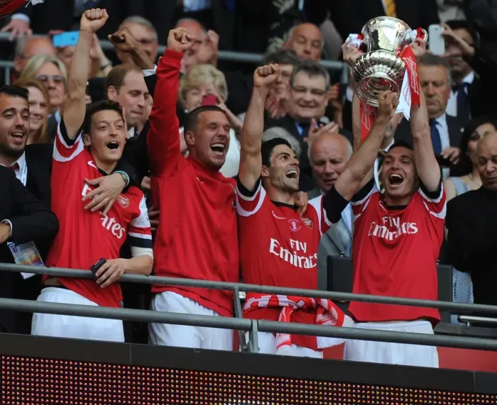 Framed Print : Arsenal FC Celebrates FA Cup Victory: Mesut Ozil, Lukas Podolski, Mikel Arteta, and Thomas Vermaelen Lift the Trophy
