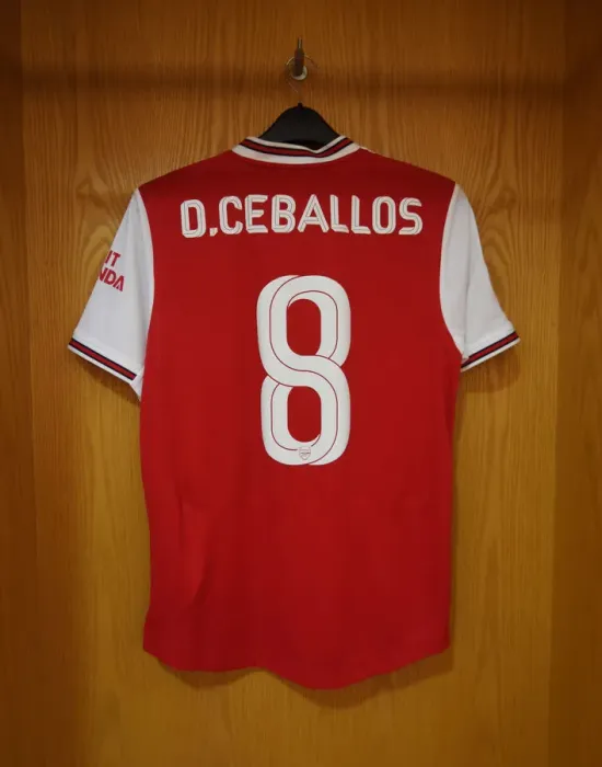 Framed Print : Arsenal FC: Dani Ceballos Hanging Shirt in Emirates Cup Home Changing Room (Arsenal v Olympique Lyonnais, 2019-20)