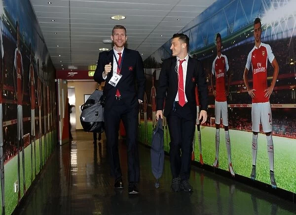 Arsenal FC: Per Mertesacker and Mesut Ozil Heading to the Changing Room before Arsenal vs. FC Barcelona - UEFA Champions League Round of 16, First Leg (2016)