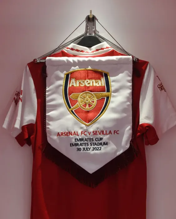 Framed Print : Arsenal FC: Pre-Season Friendly vs Sevilla - Emirates Cup 2022: Match Pennant in Changing Room