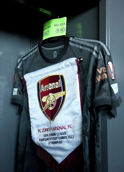 Arsenal FC Prepares for UEFA Europa League Clash against FC Zurich: Match Pennant and Captains Armband in the Changing Room