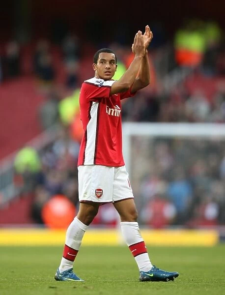 Arsenal goalkscorer Theo Walcott waves to the fans after the match