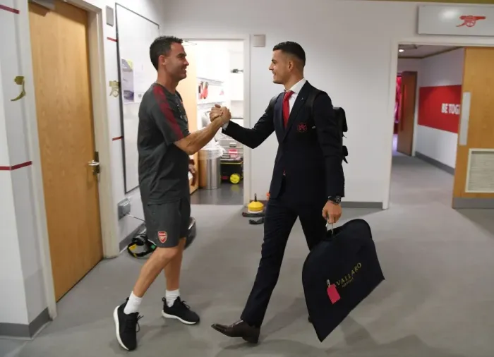 Framed Print : Arsenal: Granit Xhaka and Fitness Coach Shad Forsythe in the Home Changing Room before Arsenal v Brighton & Hove Albion, Premier League