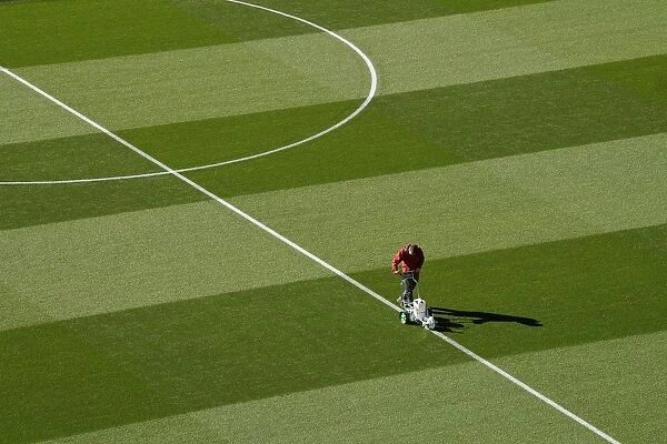 Arsenal Groundsman Meticulously Prepares Emirates Stadium Pitch for Carabao Cup Match
