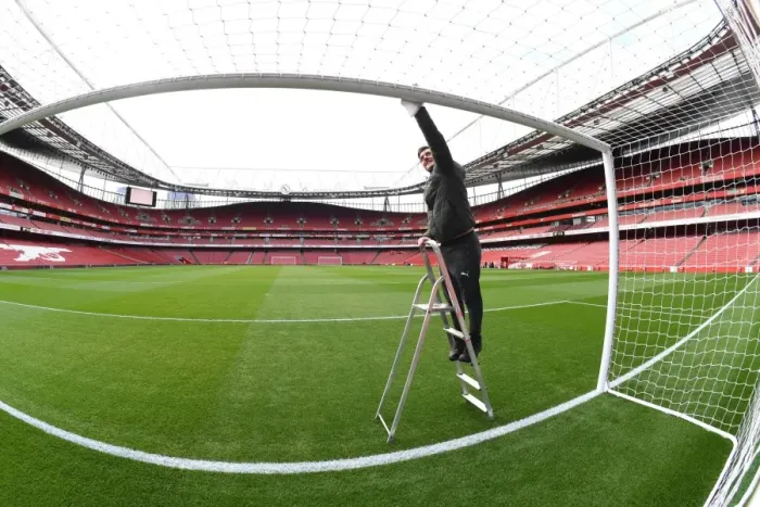 Framed Print : Arsenal Groundsman: Meticulously Preparing Emirates Stadium for Matchday