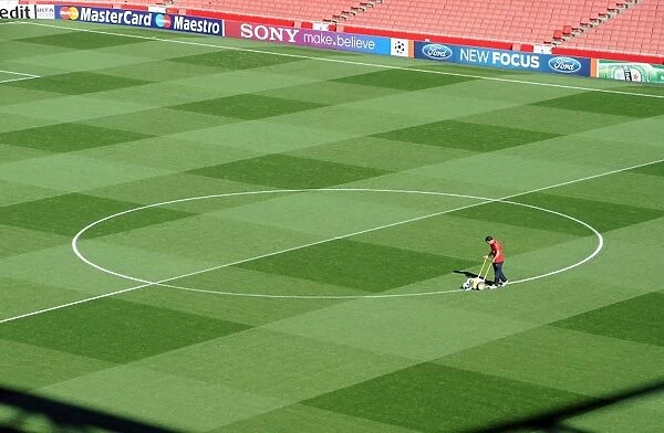 Arsenal Groundsman Paul Ashcroft marks out the pitch before the match. Arsenal 2: 1 Olympiacos