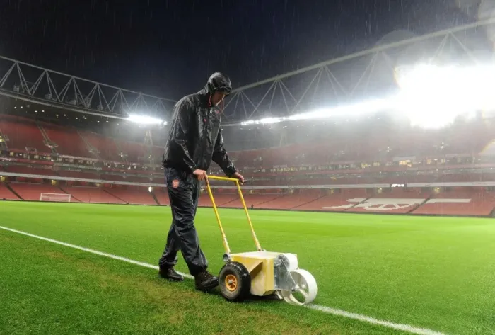 Framed Print : Arsenal Groundsman Sion Bennett Battles the Rain to Prepare for Arsenal vs. Chelsea Showdown Framed Print : Arsenal Groundsman Sion Bennett Battles the Rain to Prepare for Arsenal vs. Chelsea Showdown