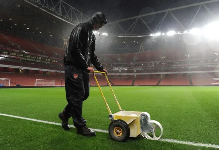 Framed Print : Arsenal Groundsman Sion Bennett Braves the Rain to Prepare for Arsenal vs. Chelsea Showdown Framed Print : Arsenal Groundsman Sion Bennett Braves the Rain to Prepare for Arsenal vs. Chelsea Showdown