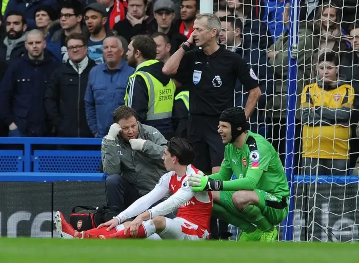 Framed Print : Arsenal: Hector Bellerin Receives Medical Assistance from Petr Cech and Colin Lewin during Chelsea Match Framed Print : Arsenal: Hector Bellerin Receives Medical Assistance from Petr Cech and Colin Lewin during Chelsea Match