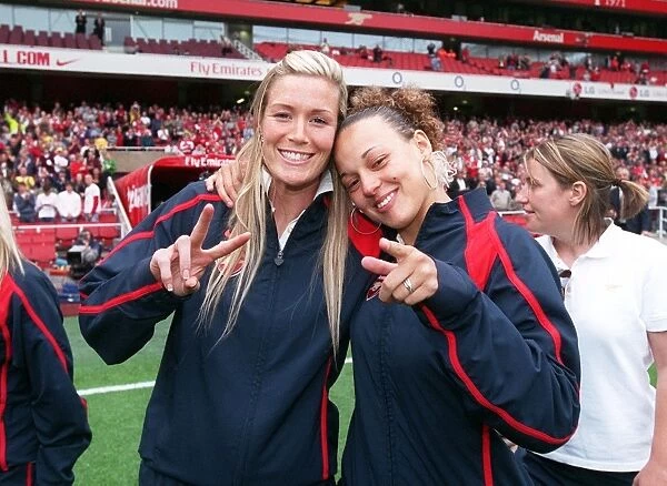 Arsenal Ladies Celebrate Womens UEFA Cup Victory at Emirates Stadium: Byrne and Sanderson Hold the Trophy