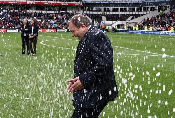 Arsenal Ladies Manager Vic Akers is covered in champange by his team