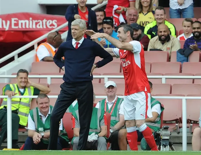 Framed Print : Arsenal Legends vs. AC Milan Glorie: A Playful Reunion - Keown's Mock Strangle of Wenger