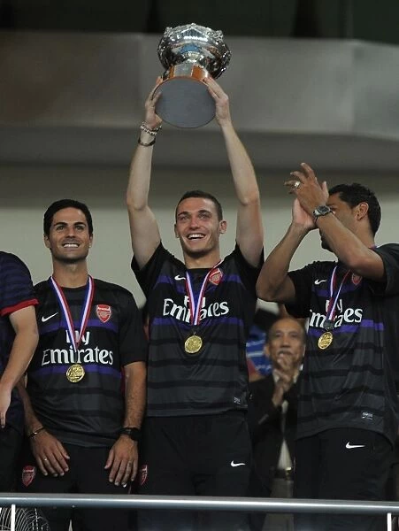 Arsenal Lift the Trophy: Thomas Vermaelen, Mikel Arteta, and Andre Santos Celebrate Victory in Malaysia, 2012