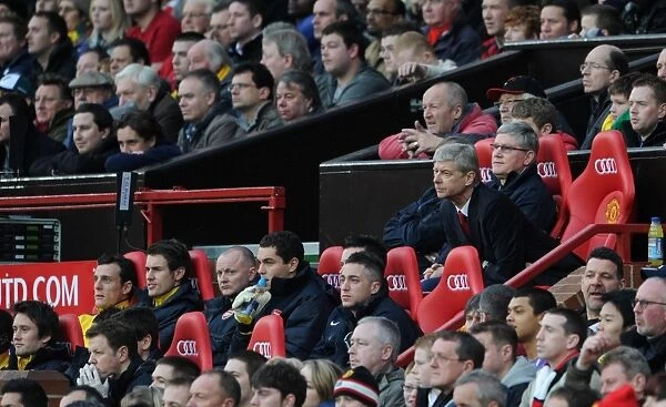 Arsenal Manager Arsene Wenger and his Assistant Pat Rice sit on the bench
