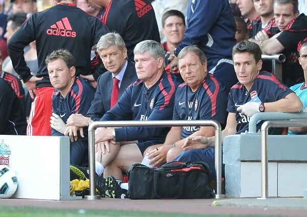 Arsenal manager Arsene Wenger on the bench with physio Colin Lewin, assistant Pat Rice