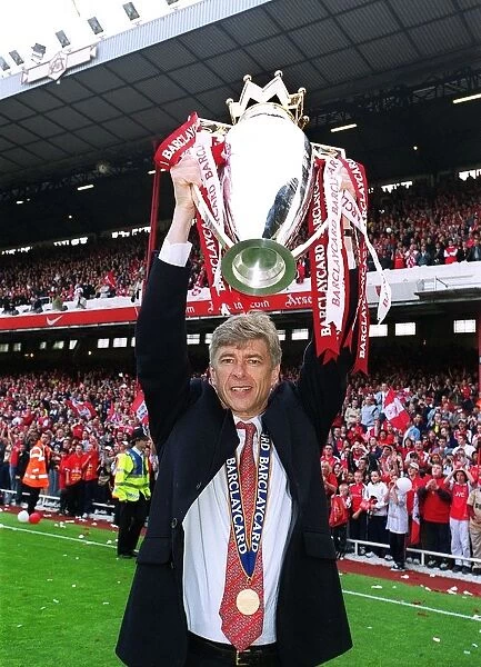 Arsenal manager Arsene Wenger lifts the F.A.Barclaycard Premiership Trophy
