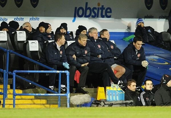 Arsenal manager Arsene Wenger with physio Colin Lewin and assistant Pat Rice during the match