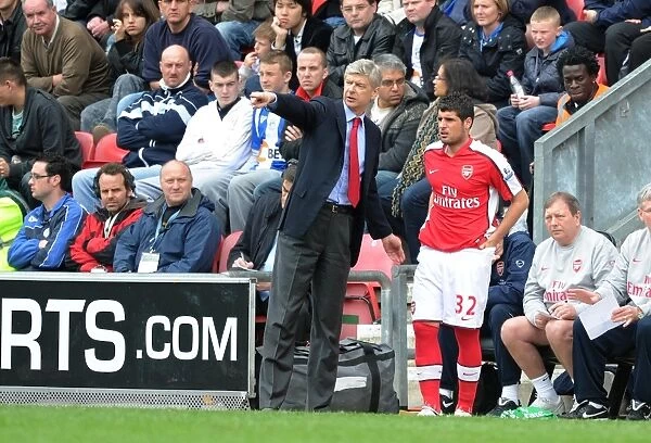 Arsenal manager Arsene Wenger with substitute Fran Merida. Wigan Athletic 3:2 Arsenal