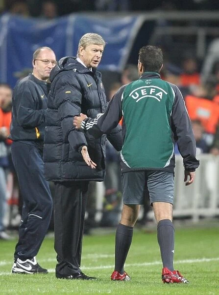 Arsenal manager Arsene Wenger talks with 4th Official