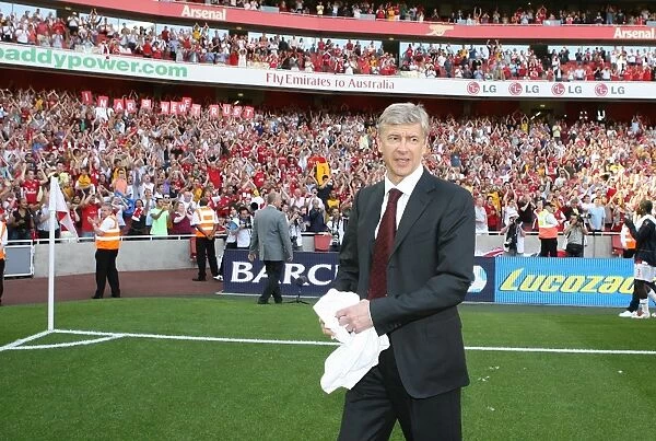 Arsenal manager Arsene Wenger waves to the fans after the match