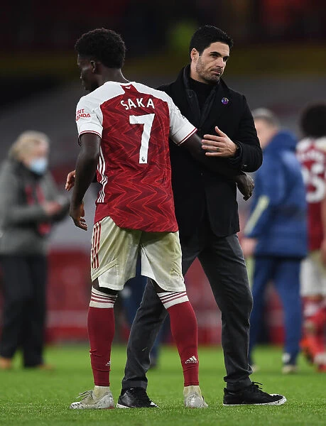 Arsenal Manager Mikel Arteta Celebrates with Bukayo Saka after Arsenal's Victory over Burnley (2020-21)