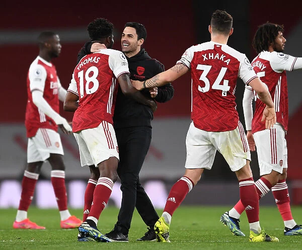 Arsenal Manager Mikel Arteta Celebrates with Thomas Partey and Granit Xhaka after Arsenal's Victory over Tottenham Hotspur (2020-21)