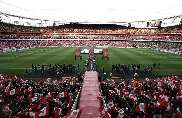 The Arsenal and Manchester united teams walk out onto the pitch