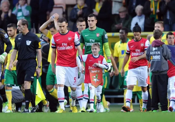 Framed Print : Arsenal mascot walks out with Thomas Vermaelen (Arsenal). Norwich City 1: 0 Arsenal Framed Print : Arsenal mascot walks out with Thomas Vermaelen (Arsenal). Norwich City 1: 0 Arsenal