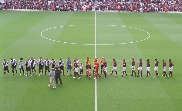 The Arsenal and Newcastle team shake hands before the match