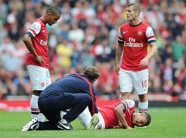 Arsenal: Oxlade-Chamberlain Receives Treatment from Physio Colin Lewin during Arsenal v Aston Villa Match, 2013-14