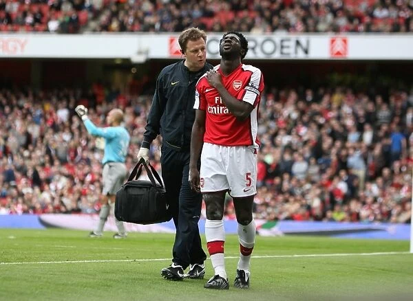 Arsenal physio Colin Lewin with injured Kolo Toure