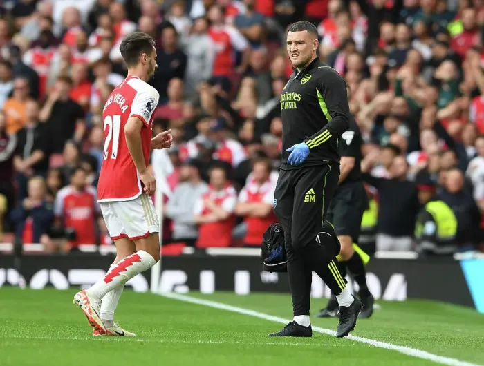 Framed Print : Arsenal Physio Simon Murphy Attends to Injured Player Amidst Intense Arsenal vs. Tottenham Clash (2023-24)