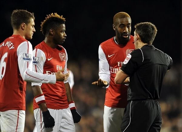 Arsenal Players Aaron Ramsey, Alex Song, and Johan Djourou Discuss with Referee Lee Probert during Fulham vs Arsenal Premier League Match