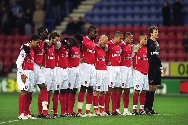 The Arsenal players line up for a minutes silence before the match